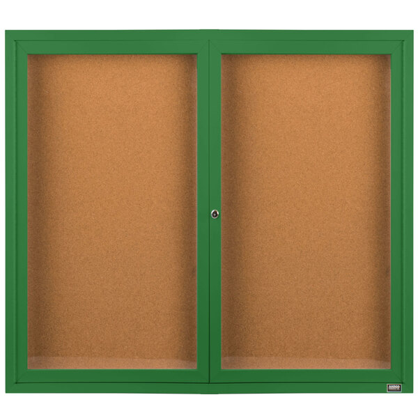 A green enclosed bulletin board cabinet with cork boards inside.