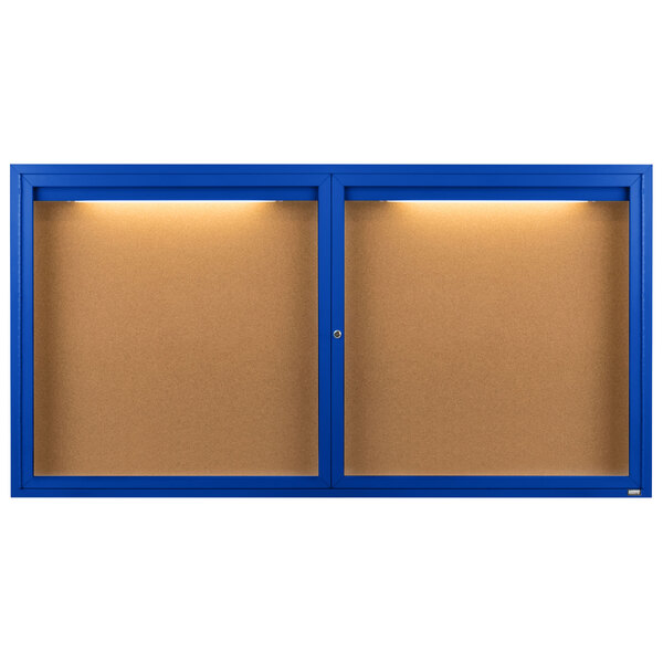 A blue framed bulletin board with two enclosed bulletin boards inside, each with a light.