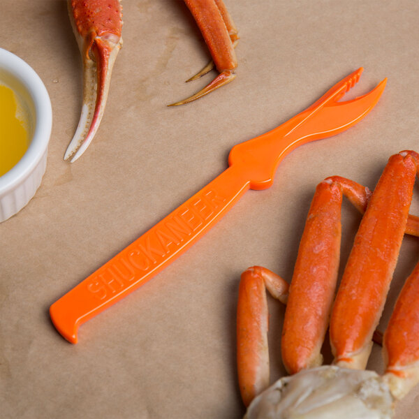 A crab claw being shelled using a Choice Shuckaneer seafood sheller.