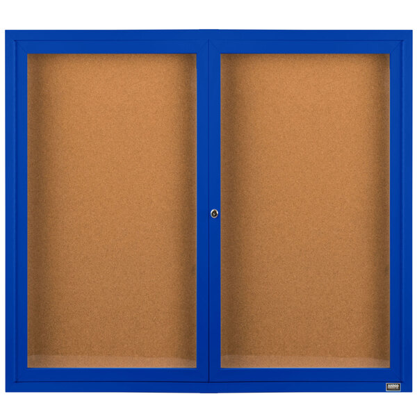 A brown rectangular cabinet with two blue doors and cork bulletin boards inside.