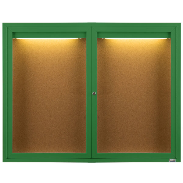 Two green Aarco enclosed bulletin board cabinets with lights.