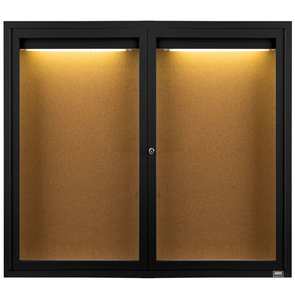 A black Aarco bulletin board cabinet with two hinged doors open to cork boards inside.