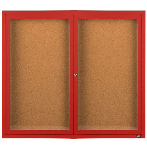 A brown cabinet with red framed cork bulletin boards.