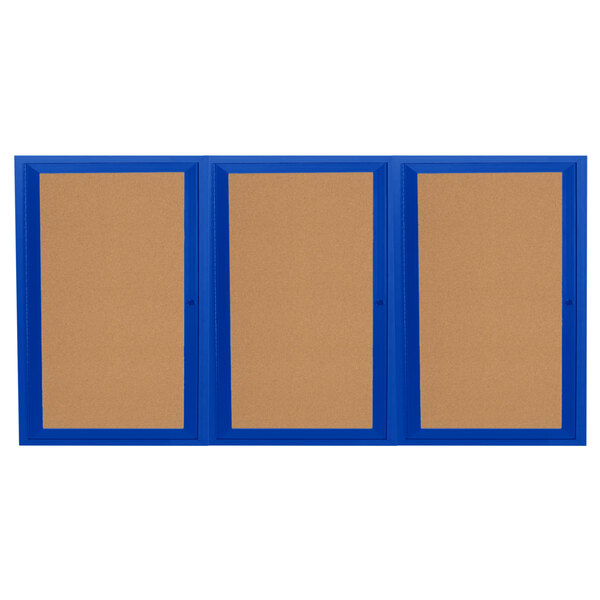 A brown bulletin board cabinet with blue framed doors holding three blue bulletin boards.