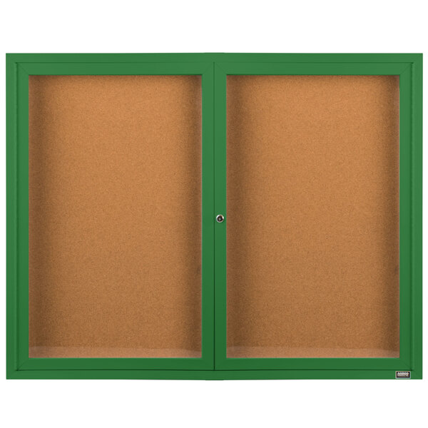 A green powder coated Aarco bulletin board cabinet with two doors enclosing two bulletin boards.