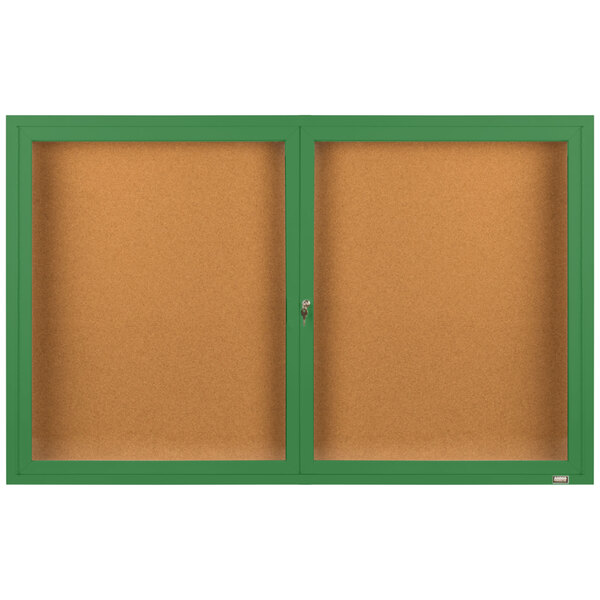 A brown rectangular bulletin board cabinet with green framed bulletin boards inside.