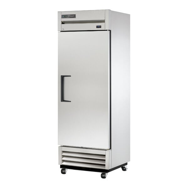 A large stainless steel True reach-in refrigerator with black handles on wheels.