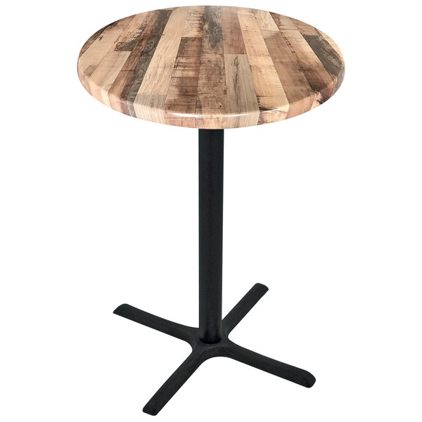 A round wooden table with a black cross base.