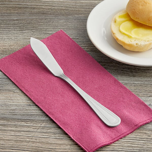 A Choice Milton stainless steel butter knife on a napkin.