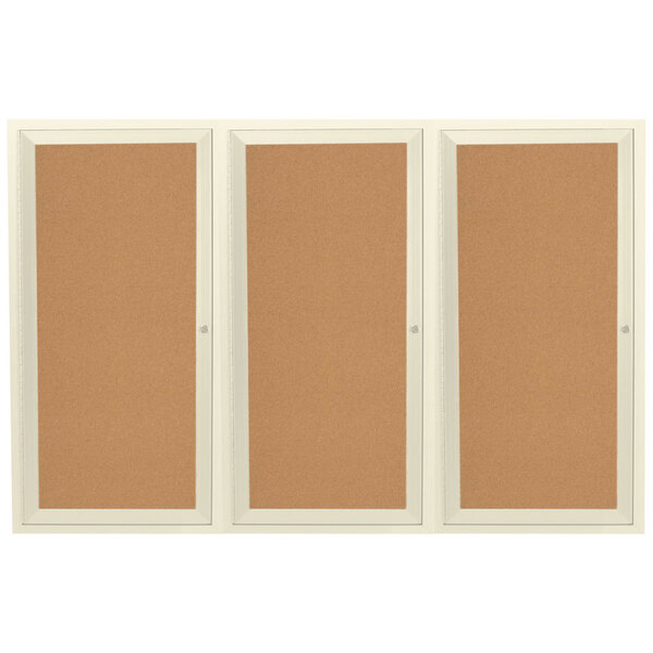 A group of white framed bulletin boards with three doors and three panels.