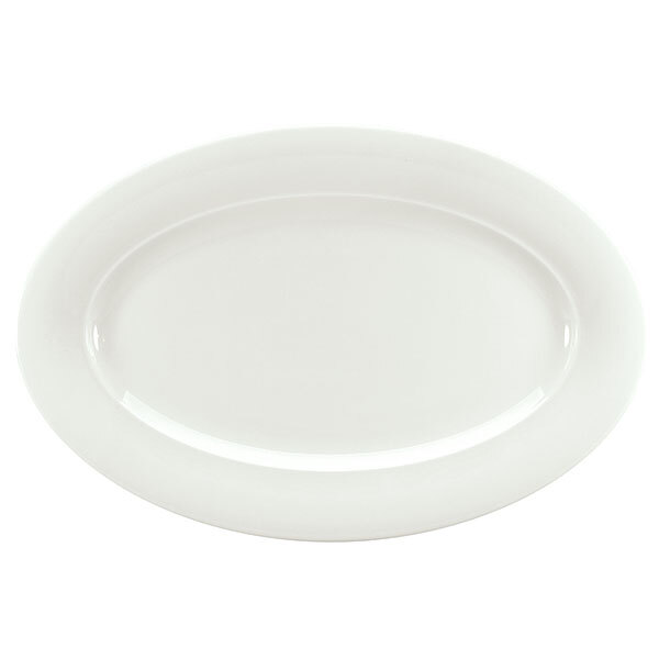 A Schonwald white porcelain oval platter with a white rim on a white background with a silver fork.
