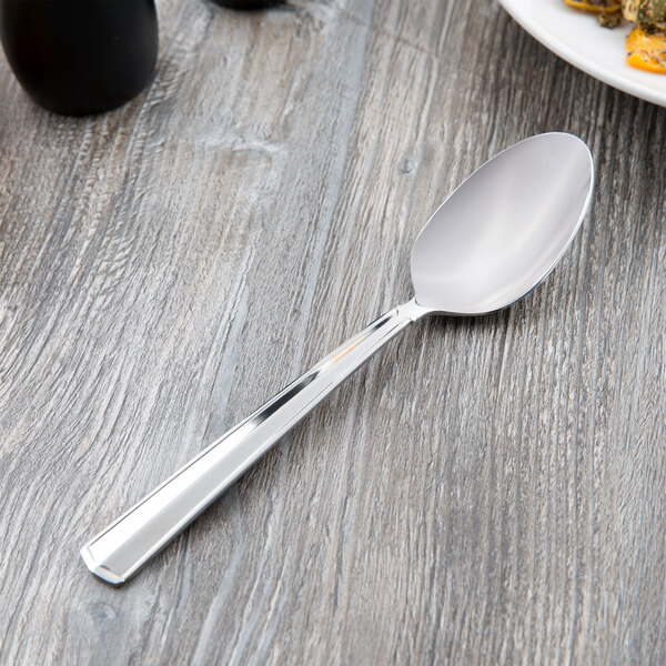 A Libbey stainless steel serving spoon on a table.