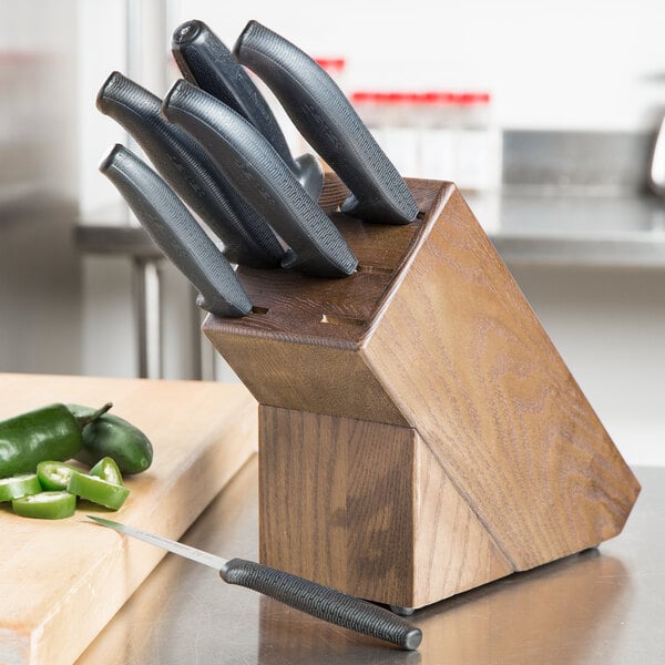 A black Dexter-Russell knife block holding a set of black knives.