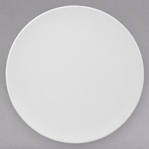 A Villeroy & Boch white porcelain coupe plate on a gray surface.