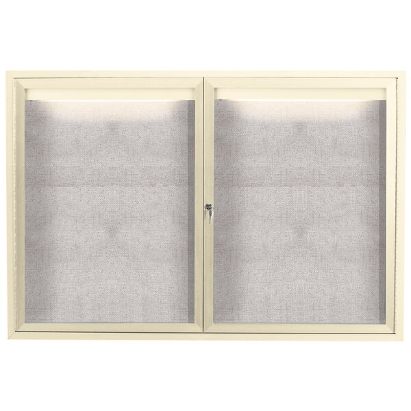 A white Aarco outdoor bulletin board cabinet with two glass doors.