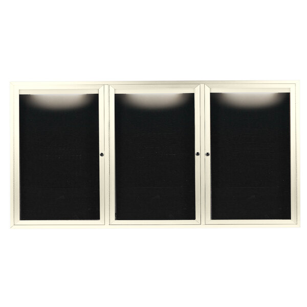 A white cabinet with three black glass doors.