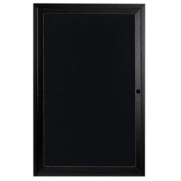 A black rectangular Aarco message center with a black frame on the door.