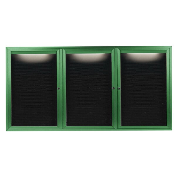 A green cabinet with black doors and a black rectangular lighted interior.