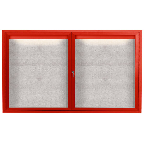 A red powder coated Aarco outdoor bulletin board cabinet with 2 doors and a white screen.