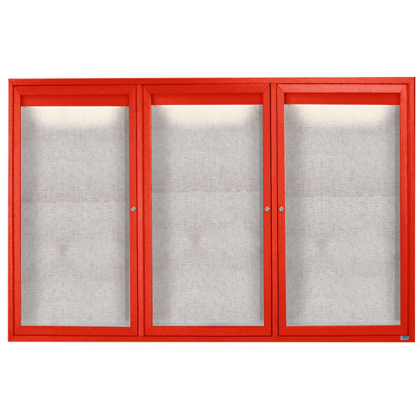 A red cabinet with white glass doors containing three white rectangular bulletin boards with red borders.
