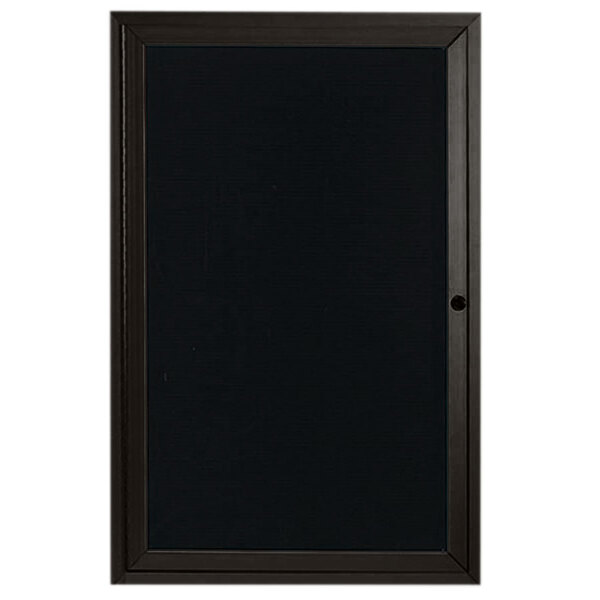 A black rectangular Aarco indoor message center with a black frame on the door.