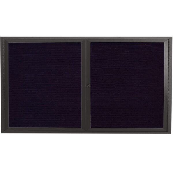 A black rectangular message center with black framed glass doors.