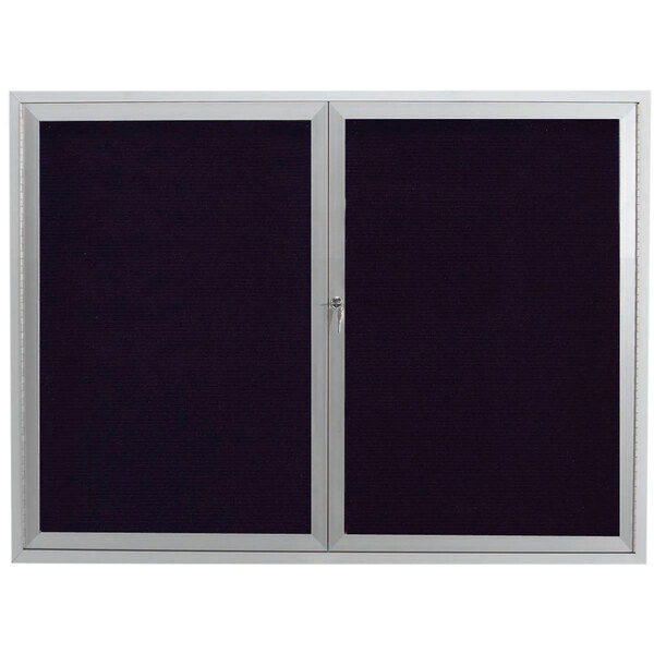 A black board with a silver frame and two black and silver doors with a black and white window.