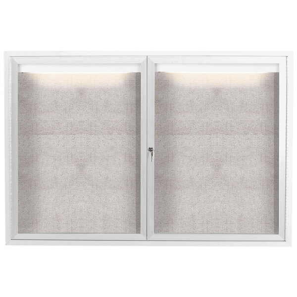 A white Aarco outdoor enclosed bulletin board with two glass doors.