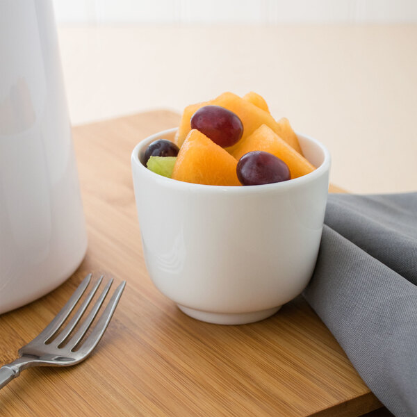A white Villeroy & Boch Affinity porcelain bowl filled with fruit on a table.