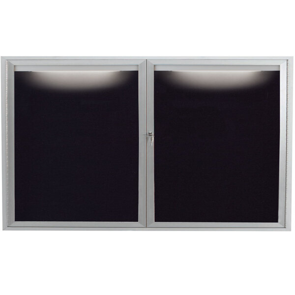 An Aarco satin anodized aluminum message center with black and white letter board windows and lights.