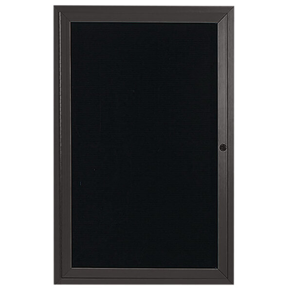 A bronze anodized aluminum door with a black letter board inside.