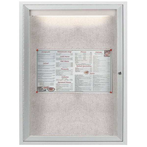 An Aarco satin anodized aluminum enclosed bulletin board with a menu inside.