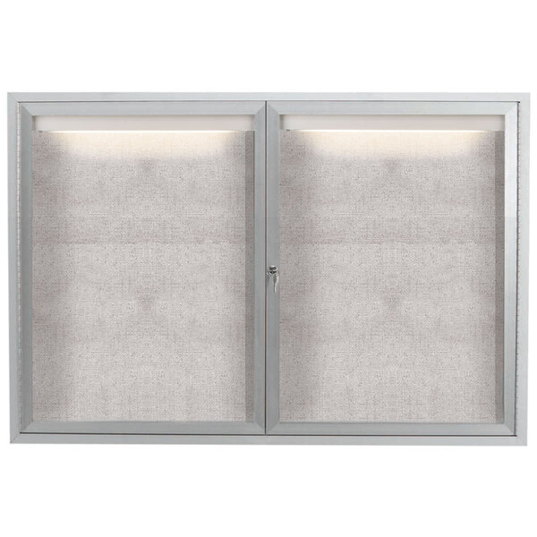 A white cabinet with glass doors on a metal frame.