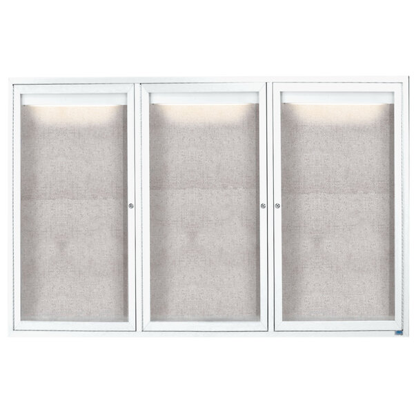 A white Aarco outdoor bulletin board cabinet with three glass doors.