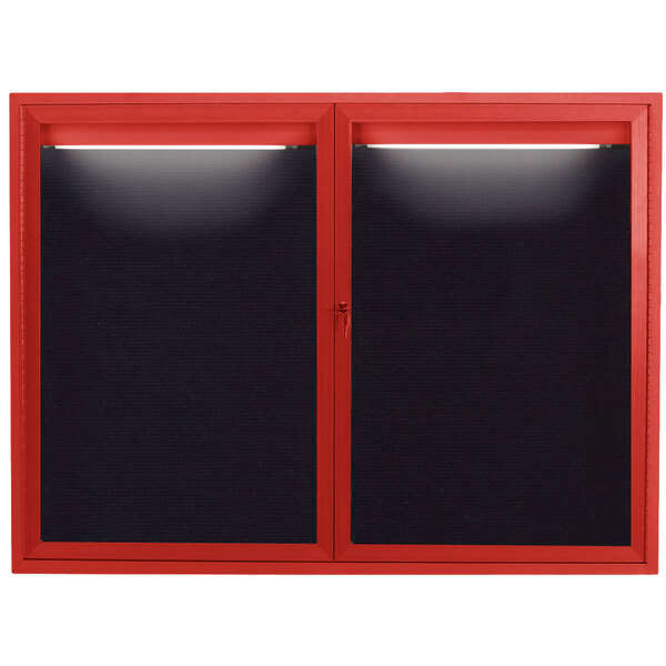 A red bulletin board with black letter board doors.