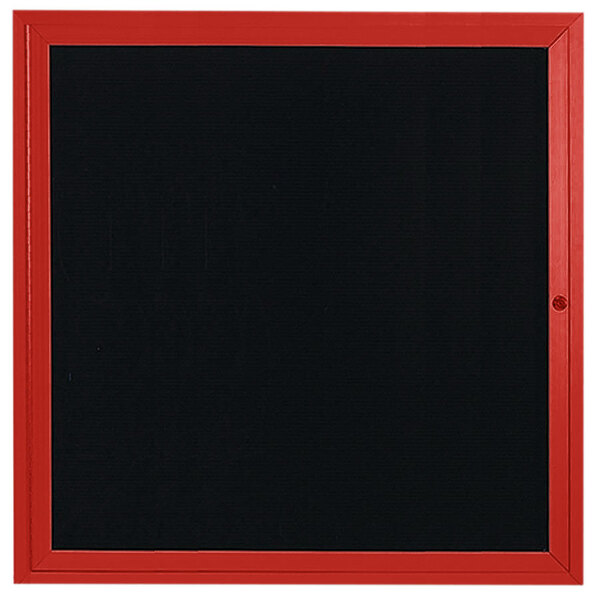 A black board with a red frame inside a red aluminum enclosed message center.