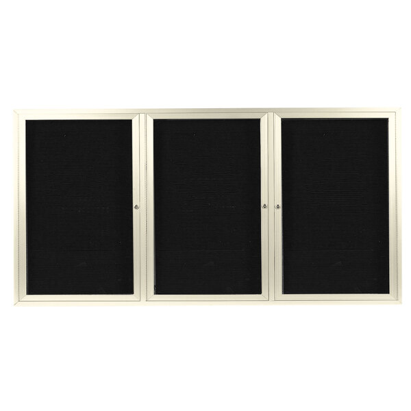 A black rectangular object with a silver frame and three white rectangular doors with black borders.