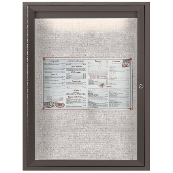A bronze anodized enclosed bulletin board with a menu in it.