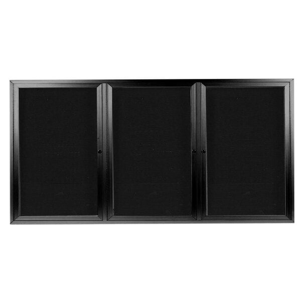 A black rectangular Aarco message center cabinet with three glass doors.