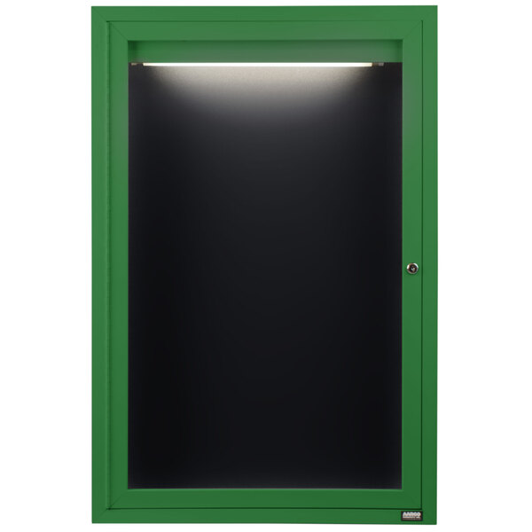 A green cabinet with a light on the door containing a black letter board.