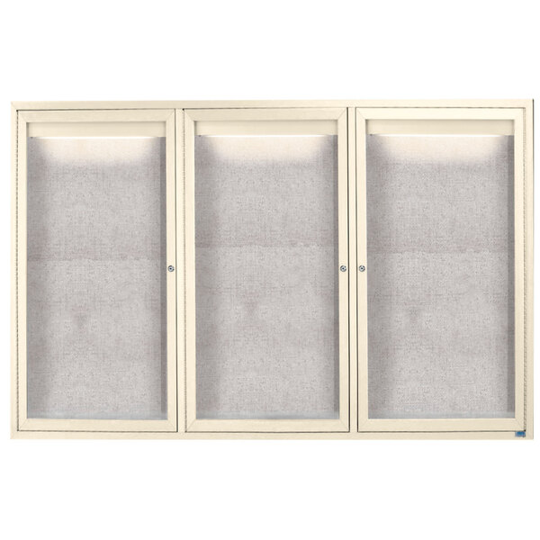 A white cabinet with a white frame and three glass doors.
