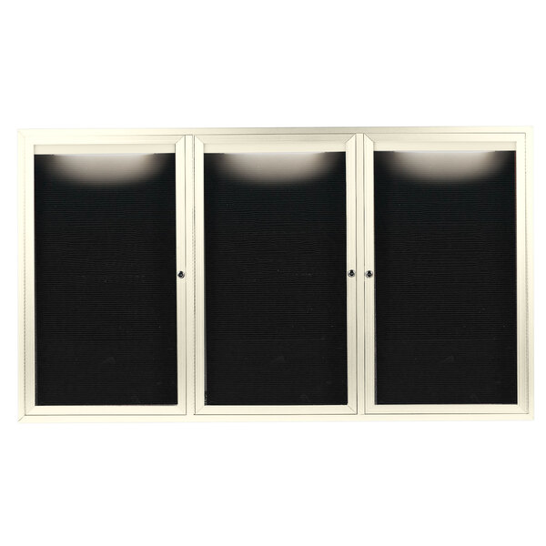 A black rectangular cabinet with three white glass doors with black letter boards inside.