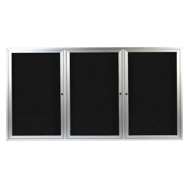 A black rectangular cabinet with three black and silver framed glass doors opening to a black letter board.
