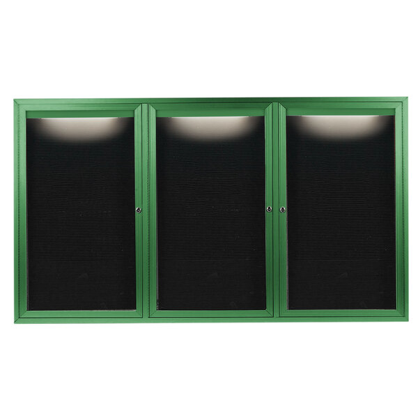A green rectangular cabinet with three black doors with green trim holding black letter boards.