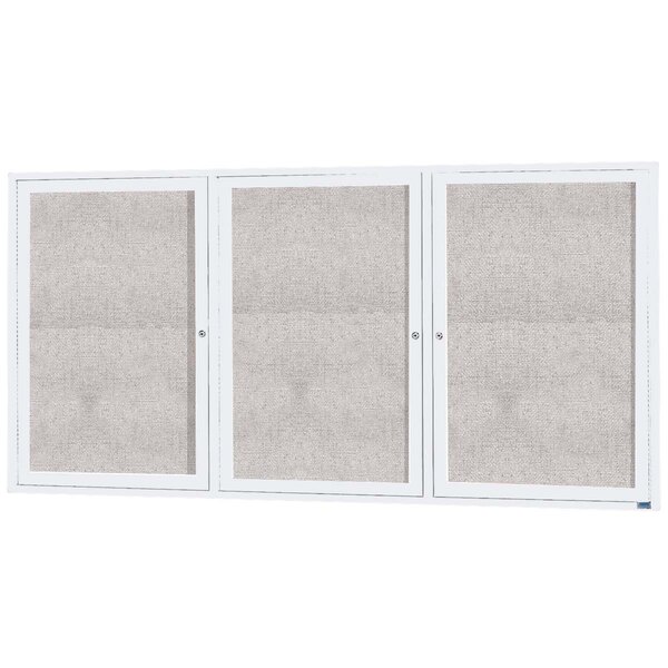 A white rectangular Aarco bulletin board cabinet with 3 white doors with glass panels.
