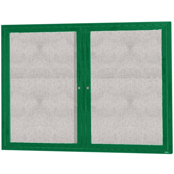 A green cabinet with white mesh enclosed by two green doors with green trim.
