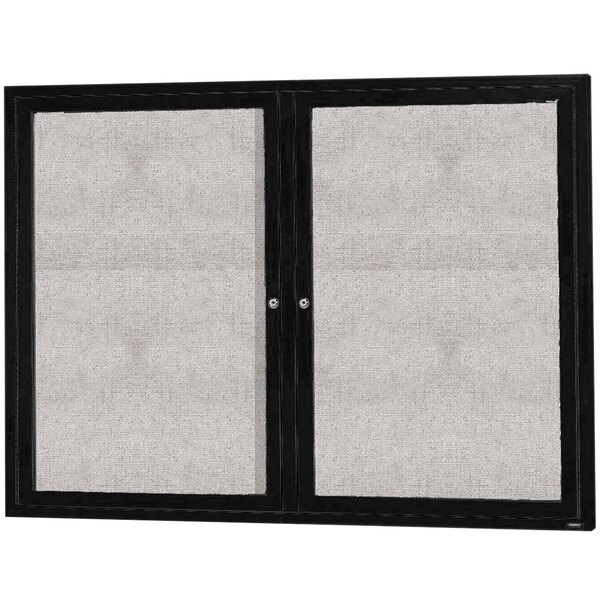 A black rectangular Aarco bulletin board cabinet with two hinged doors with glass panels.