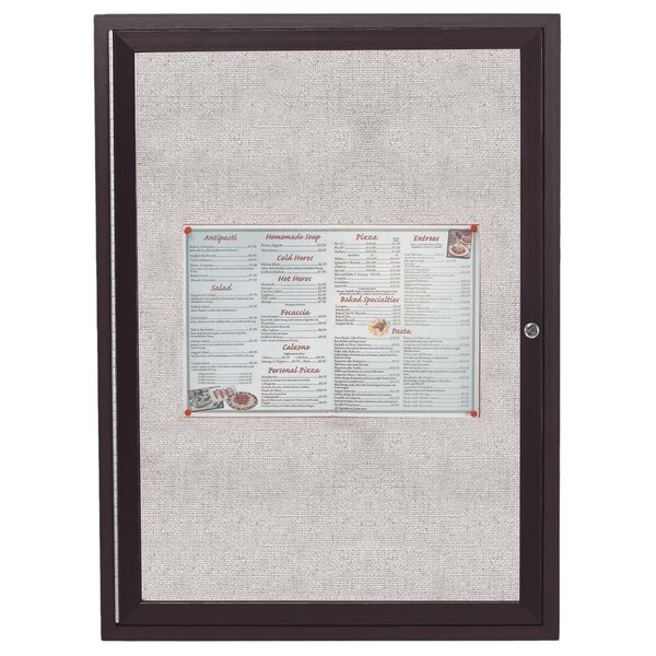 An Aarco bronze anodized bulletin board cabinet with a menu on it.