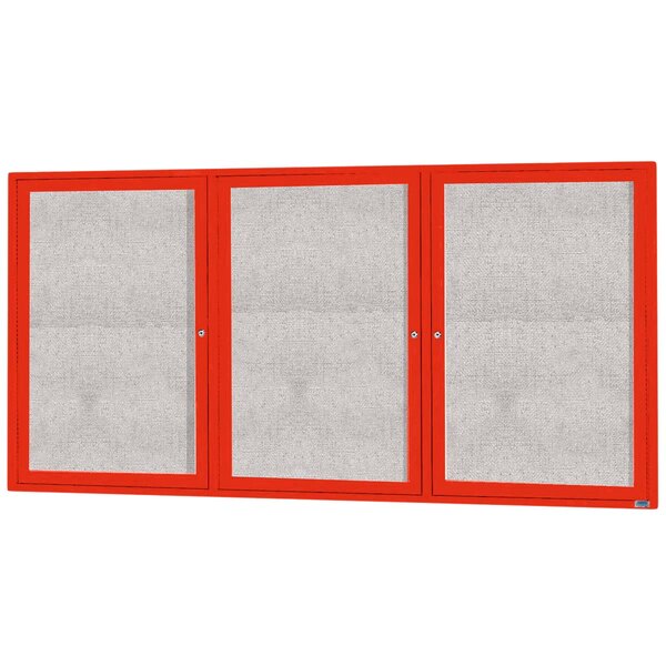 A white rectangular bulletin board cabinet with three red doors with glass panels.