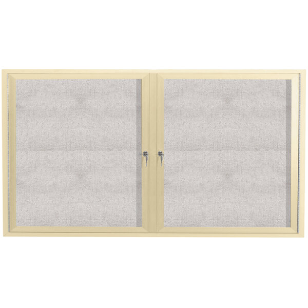 An Aarco ivory outdoor bulletin board cabinet with two doors with glass panels.